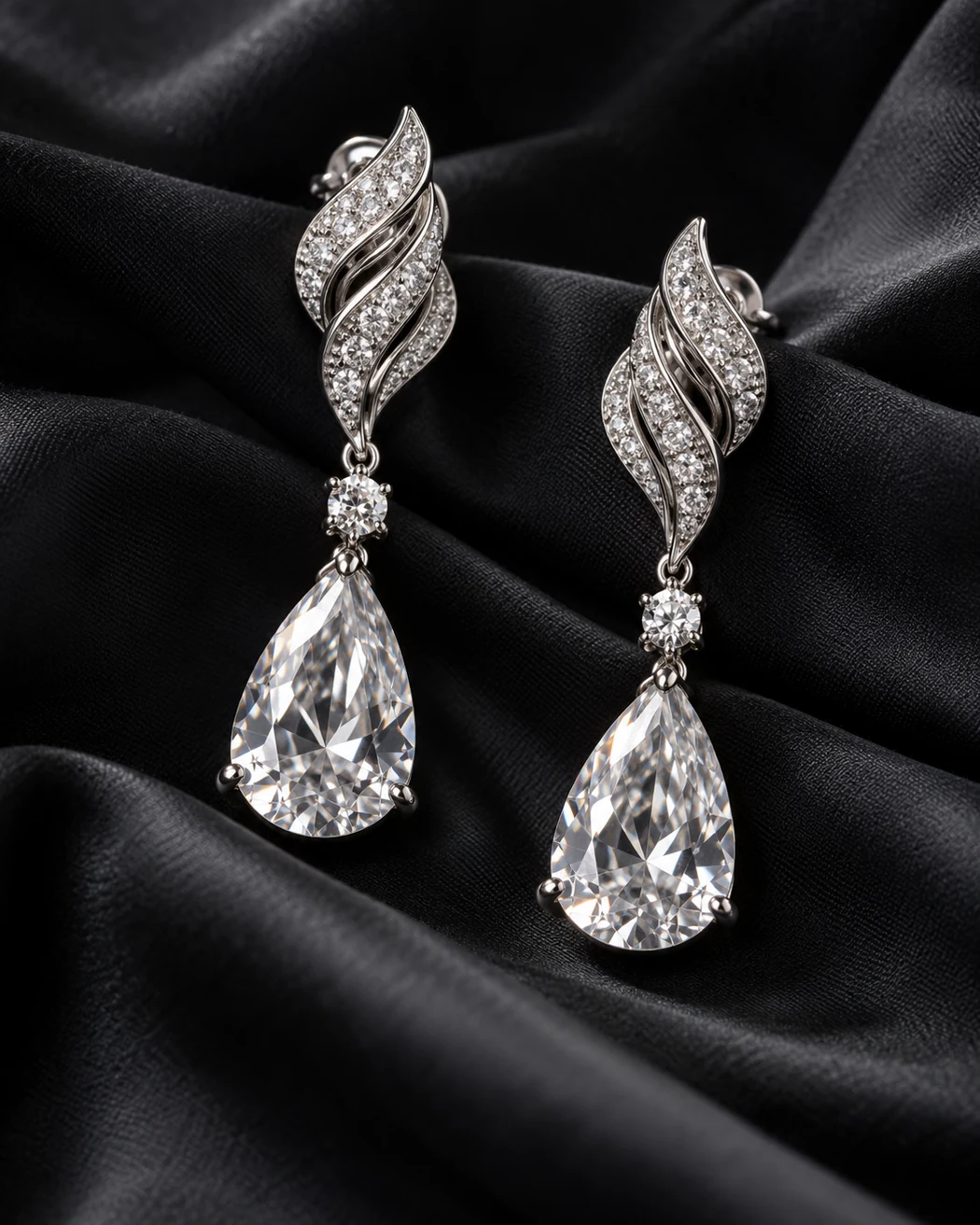Pair of silver drop earrings on charcoal silk